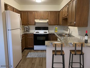 a kitchen with white appliances and wooden cabinets at Rock Creek, Billings Montana